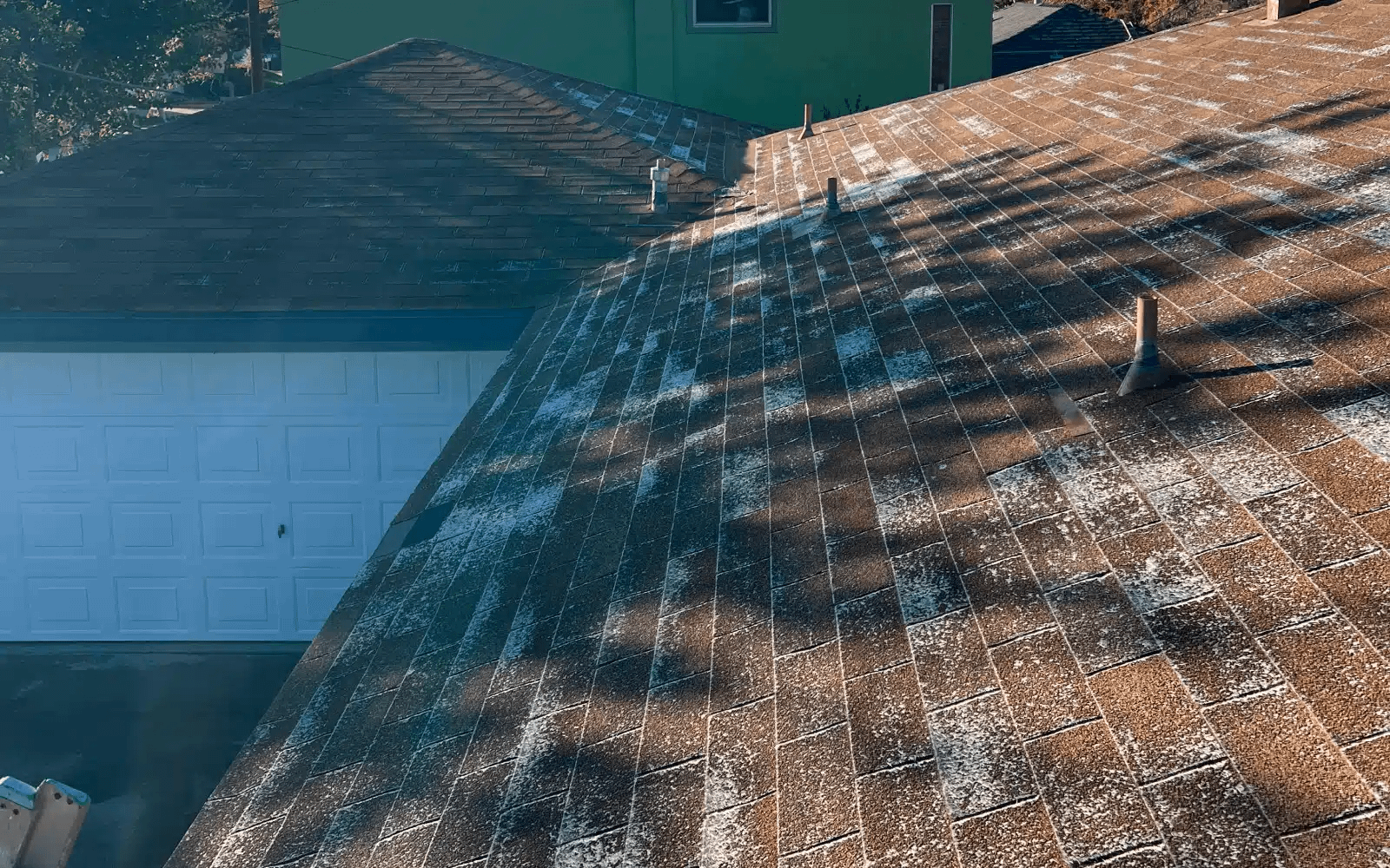 Aged asphalt shingle roof in San Carlos, San Diego, CA with visible wear around roof penetrations before Title 24–compliant cool roof replacement.
