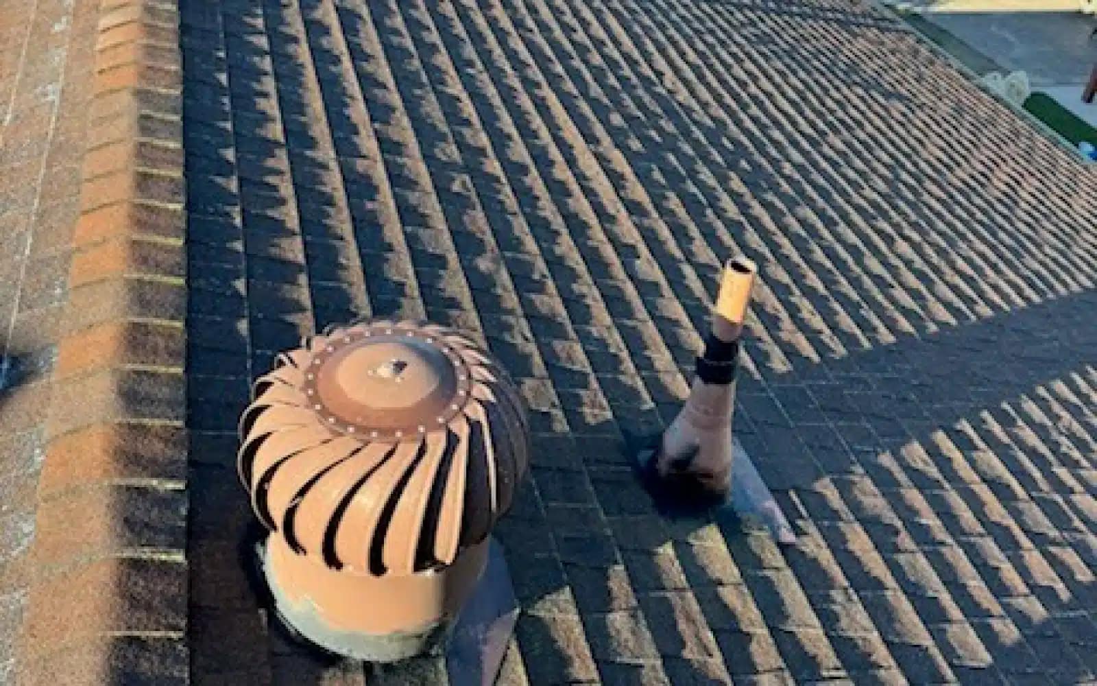 Aging asphalt shingle roof with turbine vent and plumbing vents prior to roof replacement in La Mesa, California.
