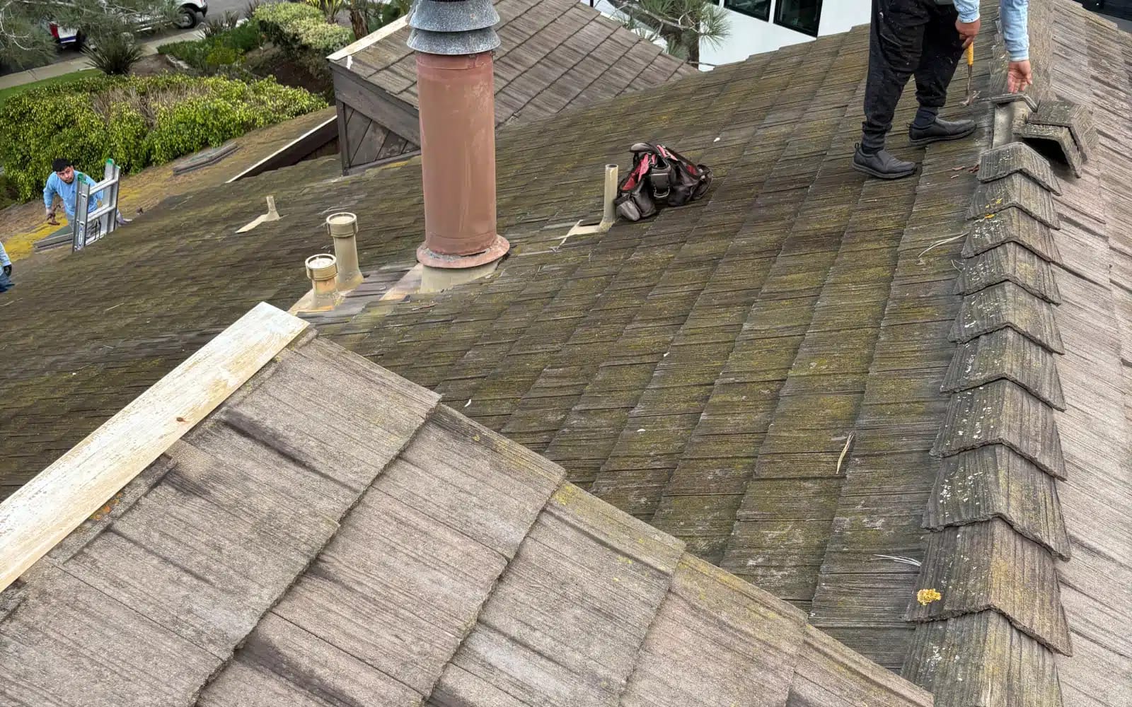 Aging lightweight concrete tile roof showing surface deterioration before full roof replacement in Del Mar, CA.