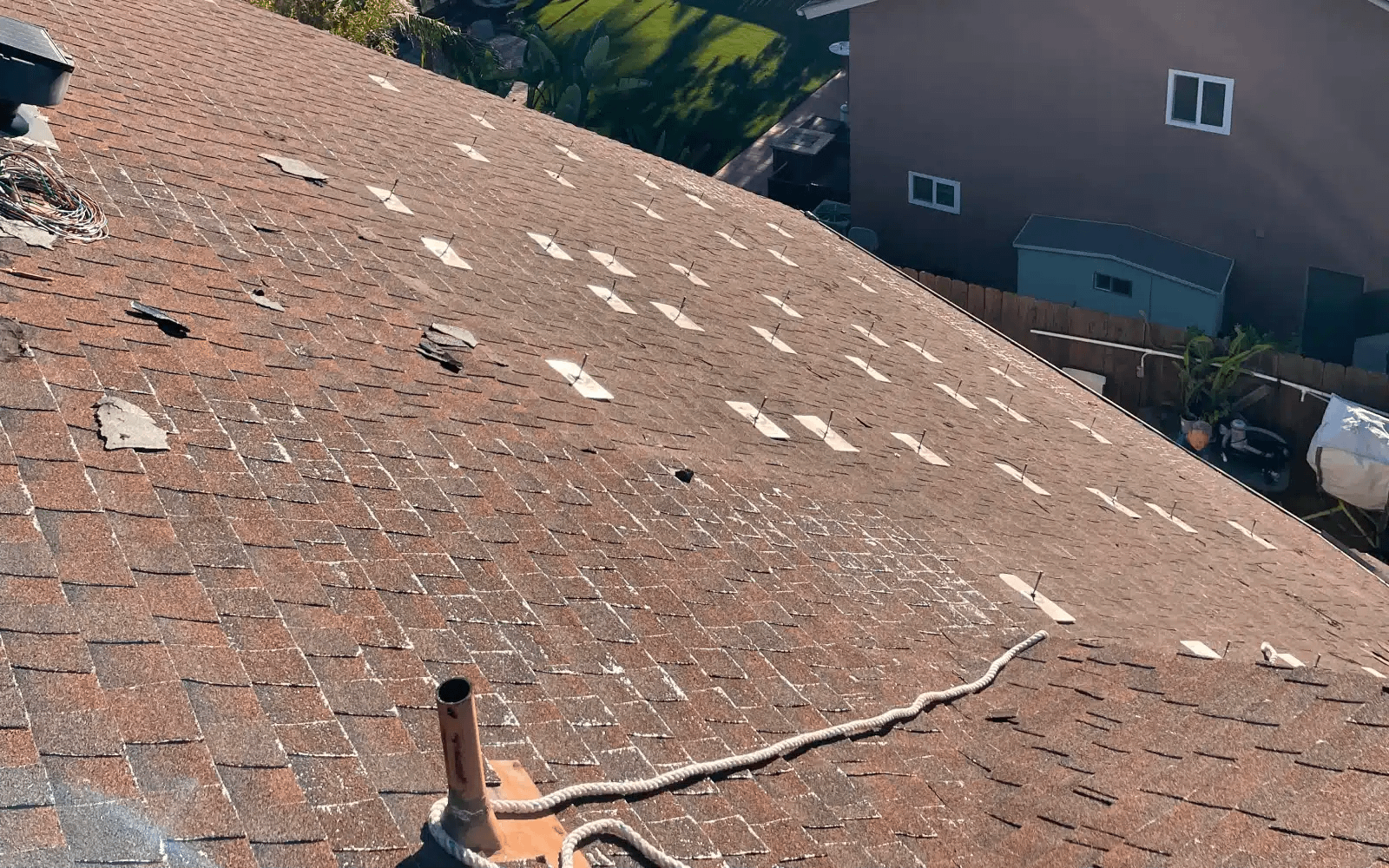 before-roof-replacement-solar-panel-stand-marks-rancho-penasquitos-ca-2 Before roof replacement with solar panels removed, showing worn asphalt shingles and exposed solar panel stand locations in Rancho Peñasquitos, CA.