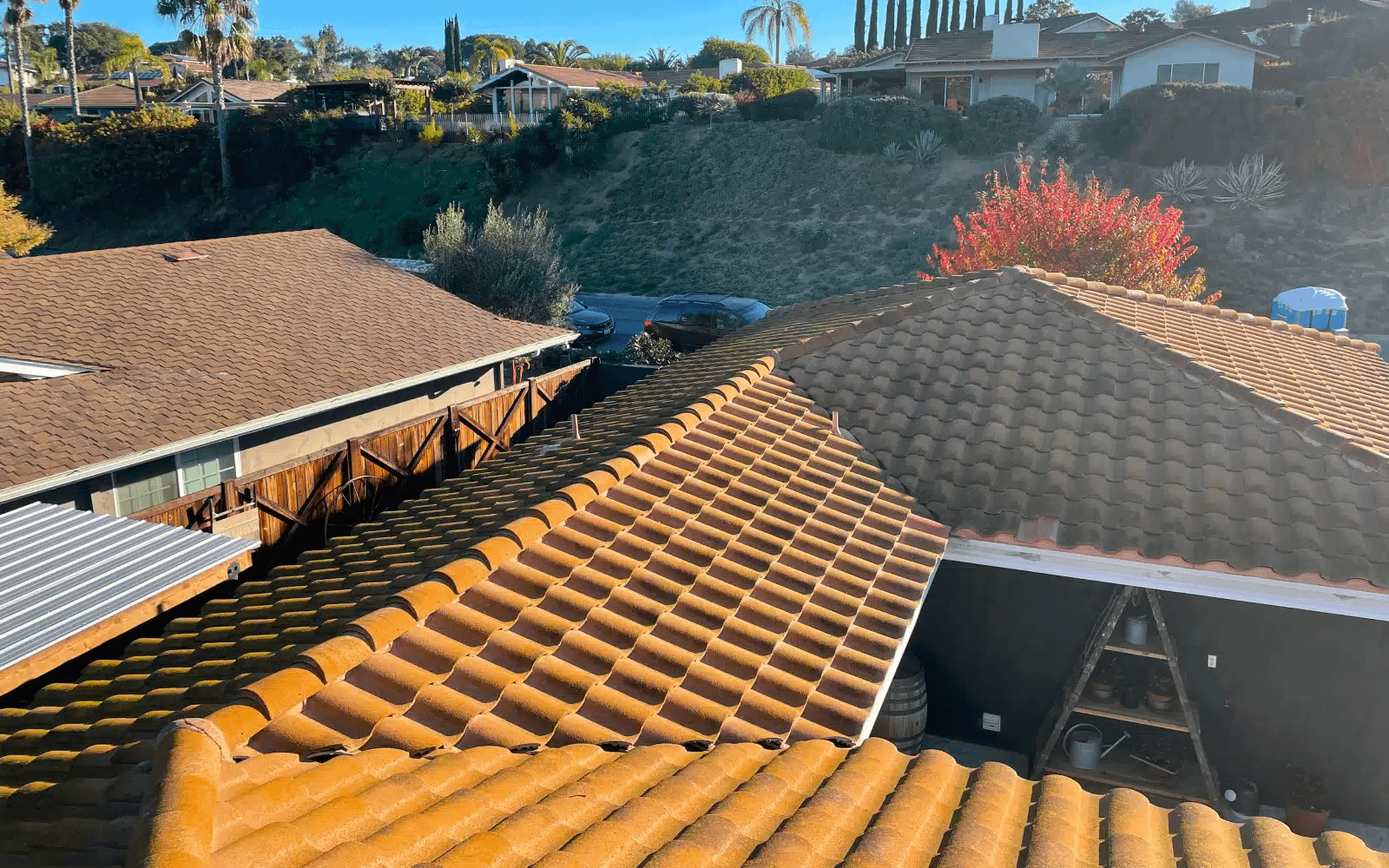 Concrete tile roof in Rancho Bernardo, CA displaying surface wear and aging tiles before coordinated concrete tile roof replacement.