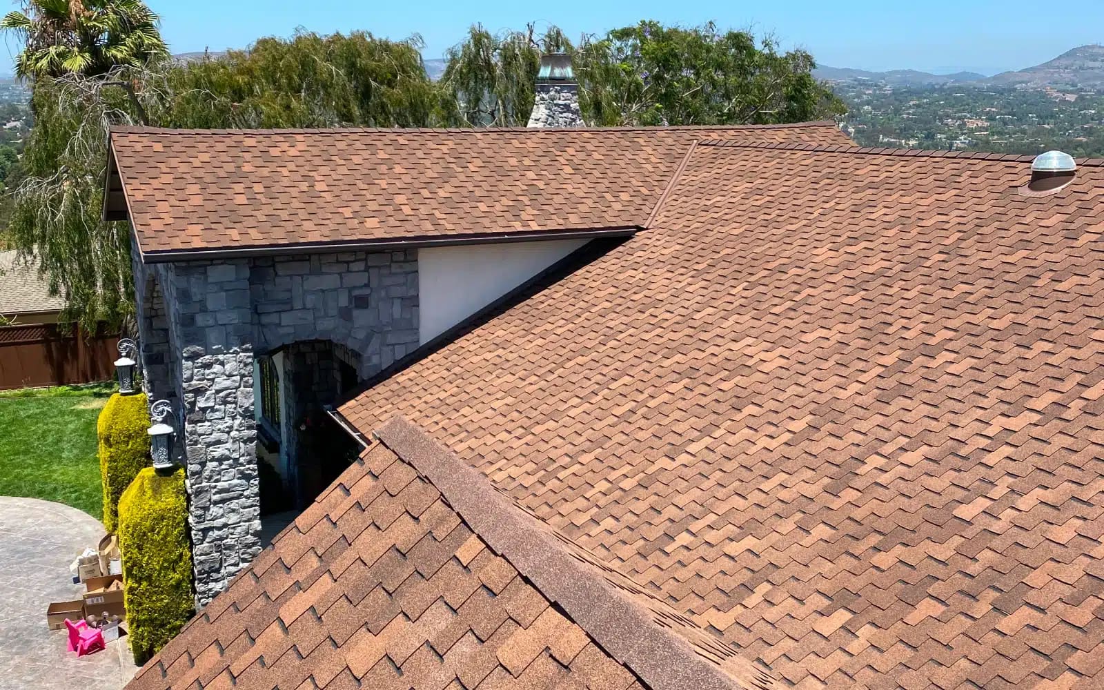 Completed asphalt shingle roof replacement in Encinitas, CA showing GAF Grand Sequoia designer shingles and clean roof planes after full system rebuild.