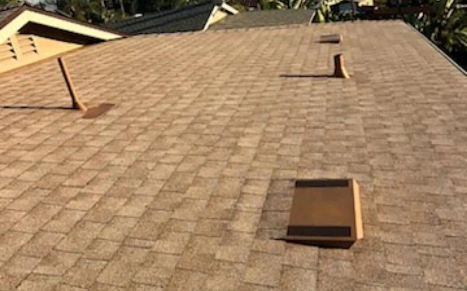 Existing asphalt shingle roof with box vents prior to a solar shingle roof replacement project in La Mesa, California.