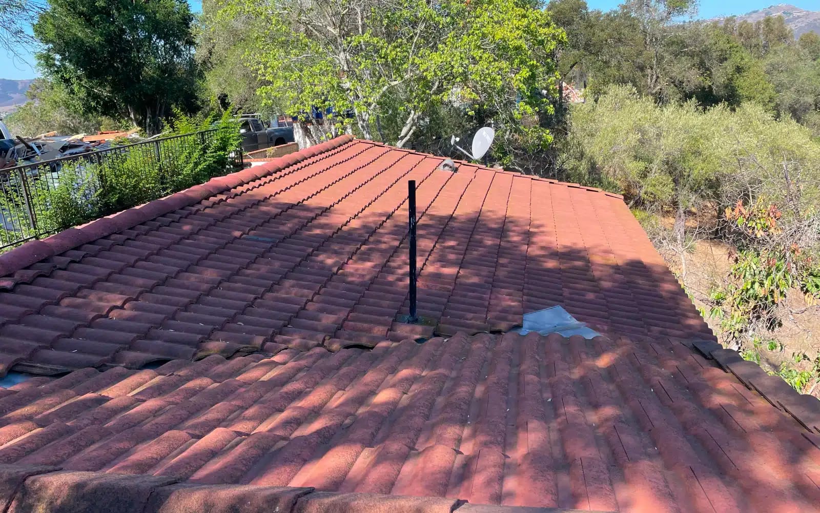 Failing concrete tile roof before replacement in San Marcos, California, showing worn tiles and poor long-term performance.