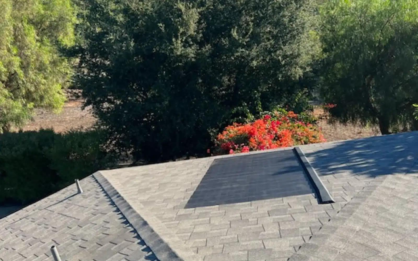 GAF Solar Roof installation showing integrated solar shingles around chimney detailing in Fallbrook, CA.
