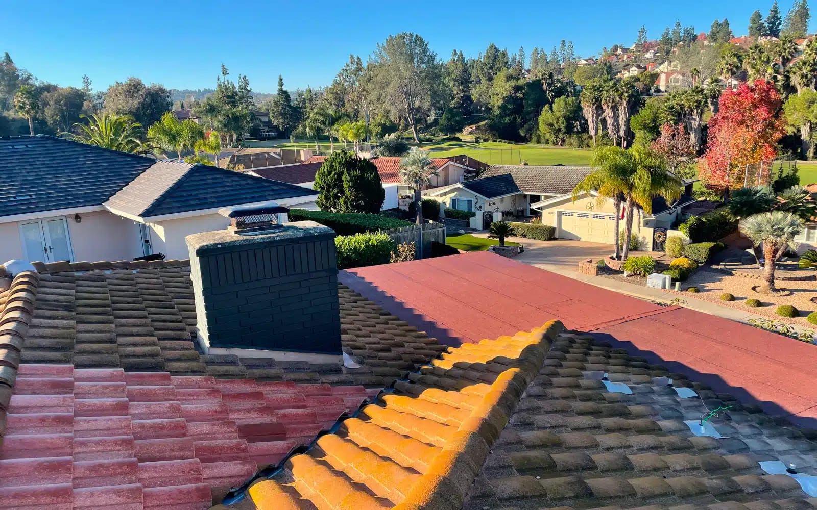 Before photo of an existing concrete tile roof in Rancho Bernardo, CA showing aged and mismatched tile sections prior to full concrete tile roof replacement.