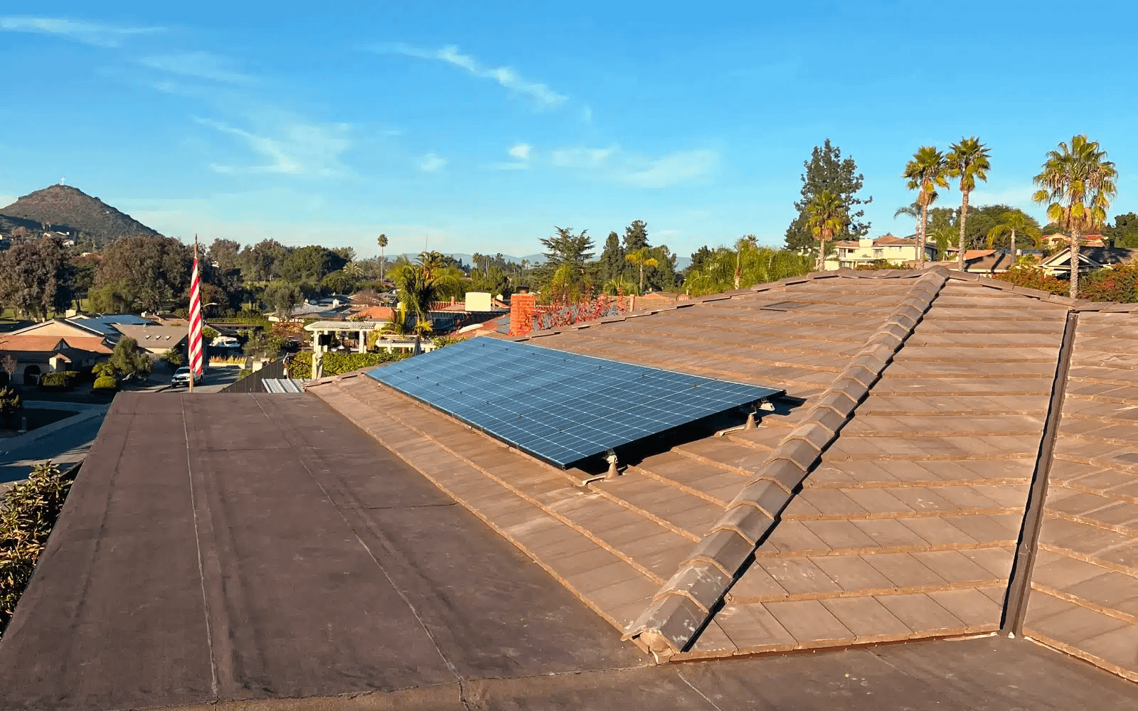 Existing concrete tile roof in Rancho Bernardo, San Diego, CA showing aged and weathered tiles prior to full roof replacement and solar panel removal.