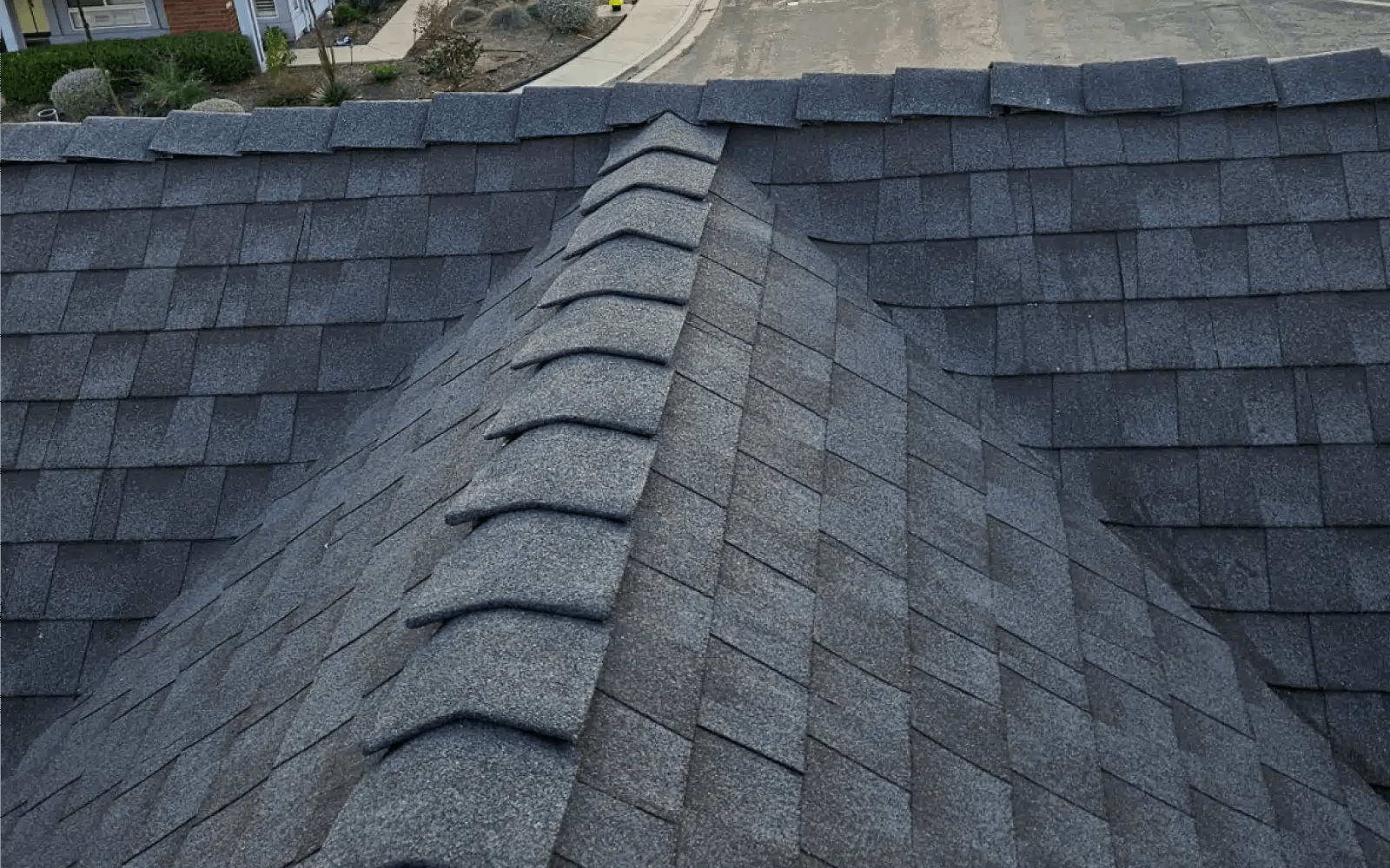 Finished asphalt shingle ridge detail after roof replacement with solar panels in Rancho Peñasquitos, CA