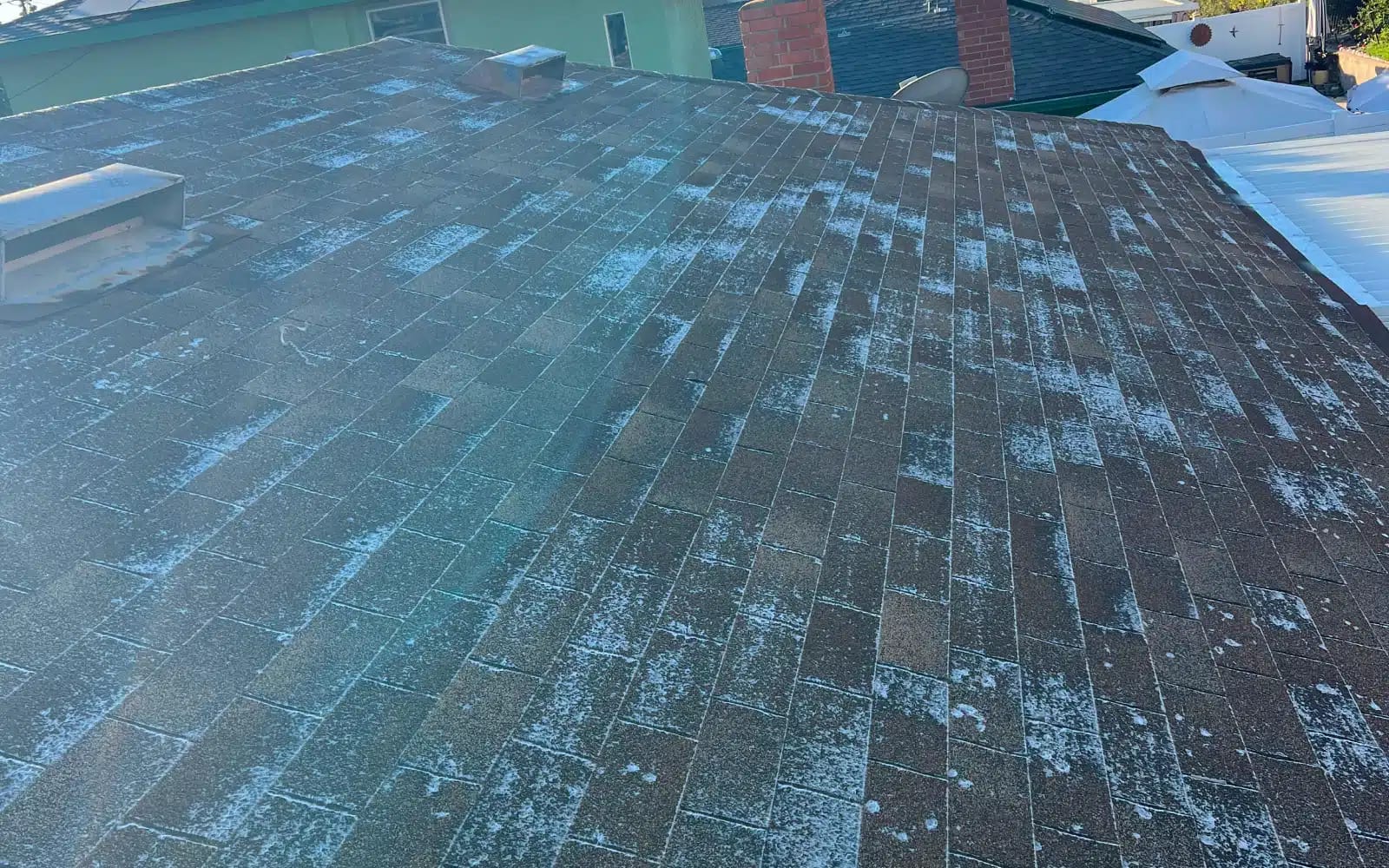 Worn asphalt shingle roof in San Carlos, San Diego, CA showing significant granule loss and aging shingles prior to cool roof replacement.