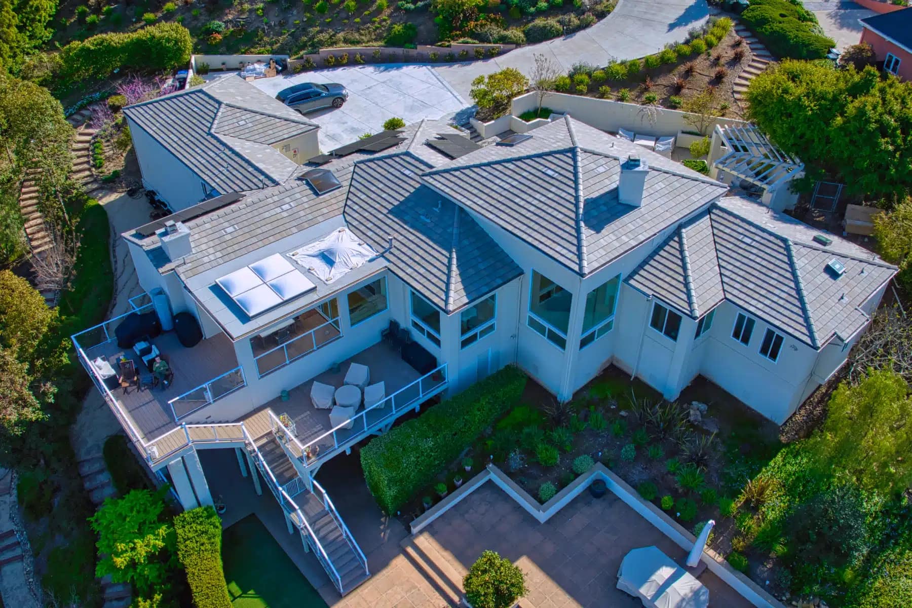 Front aerial view of a residential home with a completed tile roof replacement in San Diego.
