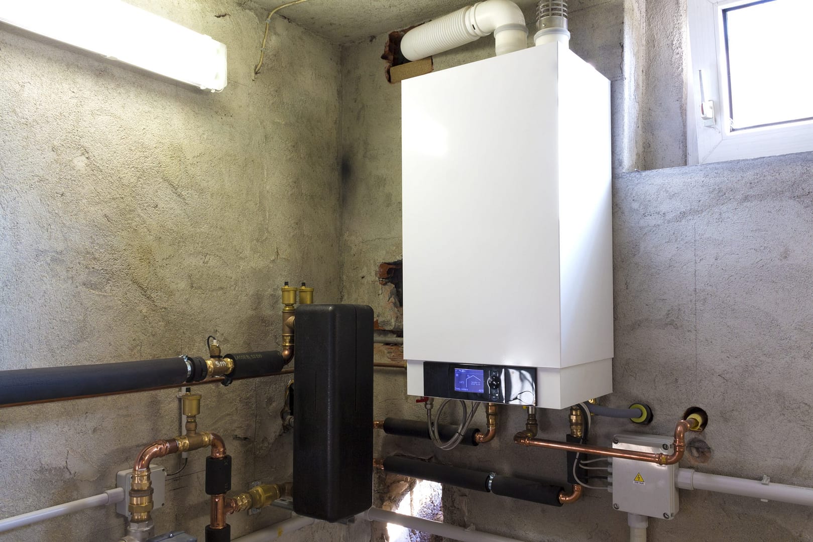 Modern boiler in a utility room. Modern boiler in a utility room.