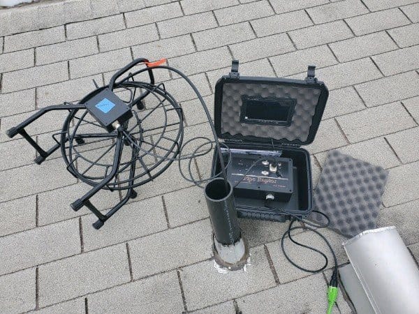 Drain camera equipment on a tiled surface to inspect unknown clog in the house Drain camera equipment on a tiled surface to inspect unknown clog in the house