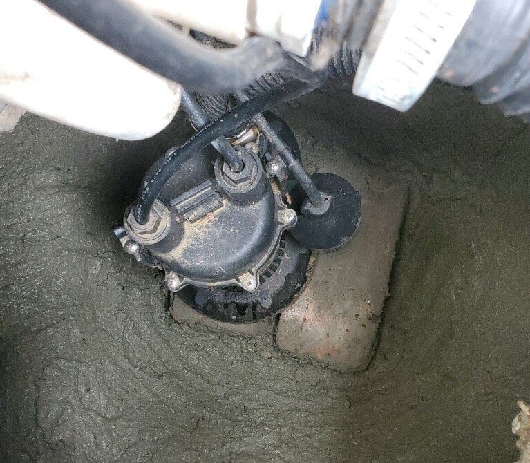 Sump pump submerged in concrete pit. Sump pump submerged in concrete pit.