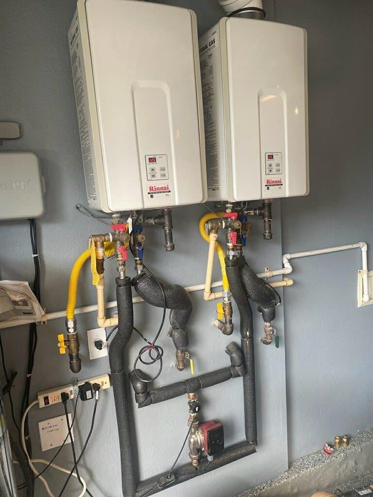 Two water heaters with connected pipes Two water heaters with connected pipes